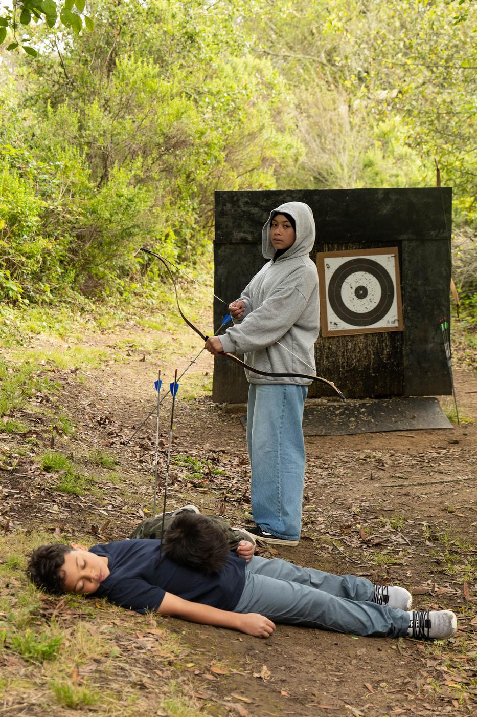 Two Futuwwah 5 students on the archery range — one taking a very theatrical approach to the safety briefing