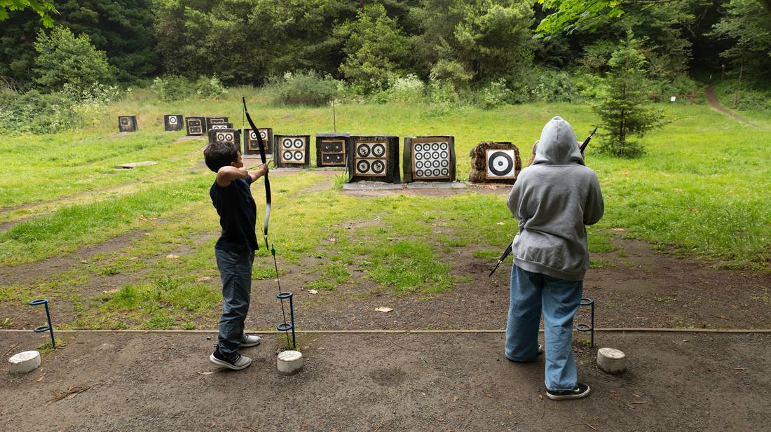 Young archers practicing on a forest archery range