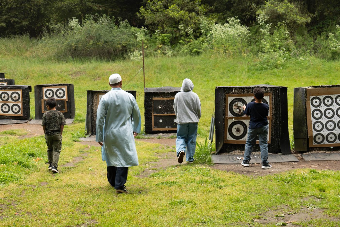Group of young students walking to the archery targets at a Futuwwah 5 session