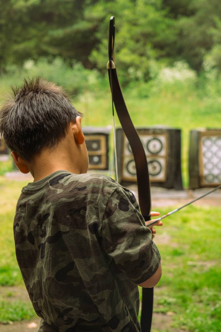 Youth archer drawing a recurve bow