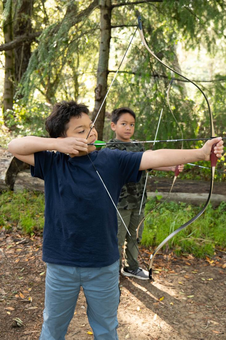 A young archer taking aim
